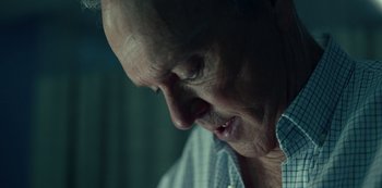 Movie still from “Dopesick” (2021), directed by Danny Strong – An older man looking down at his face; Close Up shot, Over the shoulder angle