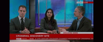 Movie still from “The Mummy” (2017), directed by Alex Kurtzman – A woman sitting in front of two other people; Medium shot, High angle