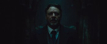 Movie still from “The Mummy” (2017), directed by Alex Kurtzman – A person wearing a suit and tie; Close Up shot, Low angle