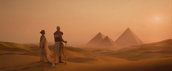 Movie still from “The Mummy” (2017), directed by Alex Kurtzman – A man in egyptian costume standing in the desert; Extreme Wide shot, Low angle