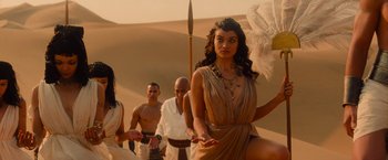 Movie still from “The Mummy” (2017), directed by Alex Kurtzman – A group of people standing in the desert; Medium shot, Over the shoulder angle
