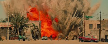 Movie still from “The Mummy” (2017), directed by Alex Kurtzman – People are running through a wall of fire and smoke; Extreme Wide shot, High angle