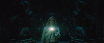 Movie still from “The Mummy” (2017), directed by Alex Kurtzman – A woman is holding a flashlight in a dark room; Medium shot, Low angle