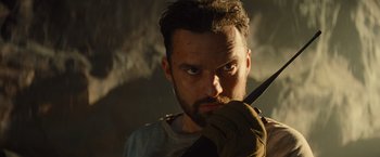 Movie still from “The Mummy” (2017), directed by Alex Kurtzman – A person holding a knife in his hand; Close Up shot, Low angle