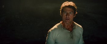 Movie still from “The Mummy” (2017), directed by Alex Kurtzman – A man in a white t - shirt is looking at the camera; Close Up shot, Over the shoulder angle