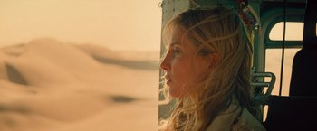 Movie still from “The Mummy” (2017), directed by Alex Kurtzman – A woman with long blonde hair looking out a window; Close Up shot, Over the shoulder angle