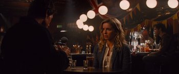 Movie still from “The Mummy” (2017), directed by Alex Kurtzman – A woman sitting in front of a man at a table; Medium shot, Over the shoulder angle