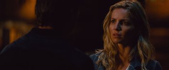 Movie still from “The Mummy” (2017), directed by Alex Kurtzman – A woman with long blonde curly hair looking at the camera; Close Up shot, Over the shoulder angle
