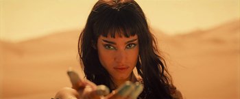 Movie still from “The Mummy” (2017), directed by Alex Kurtzman – A beautiful young lady holding a cell phone in front of her face; Close Up shot, Low angle
