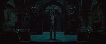 Movie still from “The Mummy” (2017), directed by Alex Kurtzman – A woman standing in front of an archway in the dark; Wide shot, Low angle