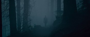Movie still from “The Mummy” (2017), directed by Alex Kurtzman – A person walking through a forest in the fog; Extreme Wide shot, Low angle