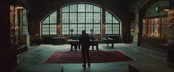 Movie still from “The Mummy” (2017), directed by Alex Kurtzman – A man standing in front of a window in a room; Wide shot, Low angle