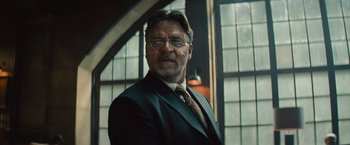 Movie still from “The Mummy” (2017), directed by Alex Kurtzman – An older man in a suit and tie; Close Up shot, Low angle