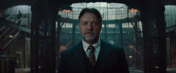 Movie still from “The Mummy” (2017), directed by Alex Kurtzman – A person wearing a suit and tie; Medium shot, Low angle