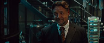 Movie still from “The Mummy” (2017), directed by Alex Kurtzman – A person wearing a suit and tie; Close Up shot, Over the shoulder angle