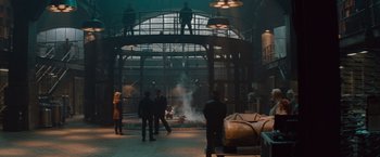 Movie still from “The Mummy” (2017), directed by Alex Kurtzman – A group of people standing around in a building; Wide shot, High angle