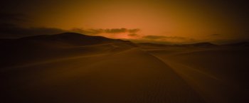 Movie still from “The Mummy” (2017), directed by Alex Kurtzman – A desert landscape with a sunset in the background; Extreme Wide shot, High angle