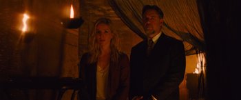 Movie still from “The Mummy” (2017), directed by Alex Kurtzman – A man and a woman standing next to each other in front of a candle; Medium shot, Over the shoulder angle