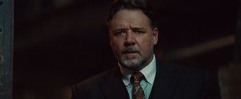 Movie still from “The Mummy” (2017), directed by Alex Kurtzman – A person wearing a suit and tie; Close Up shot, Low angle