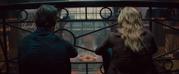 Movie still from “The Mummy” (2017), directed by Alex Kurtzman – A man and a woman looking at a fire pit; Medium shot, Over the shoulder angle