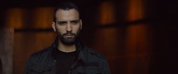 Movie still from “The Mummy” (2017), directed by Alex Kurtzman – A person wearing a jacket; Close Up shot, Low angle