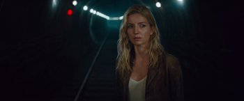 Movie still from “The Mummy” (2017), directed by Alex Kurtzman – A woman standing in a tunnel with lights on the background; Close Up shot, Low angle