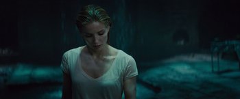 Movie still from “The Mummy” (2017), directed by Alex Kurtzman – A woman in a white shirt standing in a dark room; Close Up shot, Over the shoulder angle