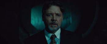 Movie still from “The Mummy” (2017), directed by Alex Kurtzman – A person wearing a suit and tie; Close Up shot, Low angle