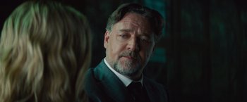 Movie still from “The Mummy” (2017), directed by Alex Kurtzman – A person wearing a suit and tie; Close Up shot, Over the shoulder angle