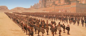 Movie still from “The Mummy Returns” (2001), directed by Stephen Sommers – A large crowd of people are gathered together in the desert; Extreme Wide shot, High angle