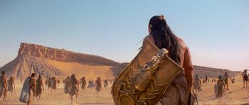 Movie still from “The Mummy Returns” (2001), directed by Stephen Sommers – A group of people walking through the desert; Medium shot, Over the shoulder angle