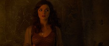 Movie still from “The Mummy Returns” (2001), directed by Stephen Sommers – A beautiful woman standing in front of a wall; Close Up shot, Overhead angle