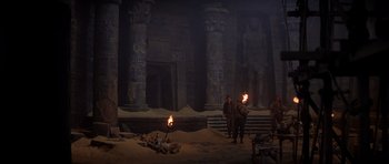 Movie still from “The Mummy Returns” (2001), directed by Stephen Sommers – A group of people standing around in the dark; Extreme Wide shot, Low angle