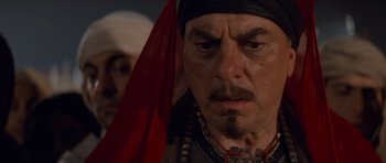 Movie still from “The Mummy Returns” (2001), directed by Stephen Sommers – A person wearing a headdress; Close Up shot, Over the shoulder angle