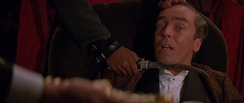 Movie still from “The Mummy Returns” (2001), directed by Stephen Sommers – A man being held down by another man's arm; Close Up shot, Overhead angle