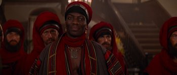 Movie still from “The Mummy Returns” (2001), directed by Stephen Sommers – A group of men in red and black clothing; Close Up shot, Low angle