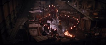 Movie still from “The Mummy Returns” (2001), directed by Stephen Sommers – A group of people standing next to a fire pit at night; Extreme Wide shot, High angle