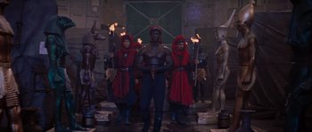 Movie still from “The Mummy Returns” (2001), directed by Stephen Sommers – A group of people standing next to each other holding torches; Wide shot, High angle