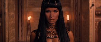 Movie still from “The Mummy Returns” (2001), directed by Stephen Sommers – A woman with long black hair wearing a necklace; Close Up shot, Overhead angle