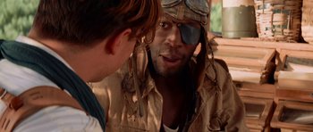 Movie still from “The Mummy Returns” (2001), directed by Stephen Sommers – A man wearing a pirate eye patch talking to another man; Close Up shot, Over the shoulder angle