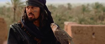 Movie still from “The Mummy Returns” (2001), directed by Stephen Sommers – A man with a bird on his arm and face; Close Up shot, Low angle