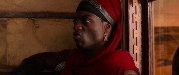 Movie still from “The Mummy Returns” (2001), directed by Stephen Sommers – A man in a red scarf and a black hat; Close Up shot, Low angle