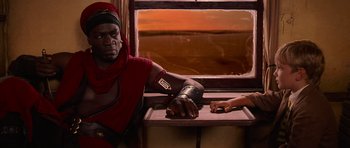 Movie still from “The Mummy Returns” (2001), directed by Stephen Sommers – A man in a red shirt and a woman in a red dress; Medium shot, Over the shoulder angle