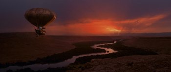 Movie still from “The Mummy Returns” (2001), directed by Stephen Sommers – A hot air balloon flying over a river at sunset; Extreme Wide shot, Low angle