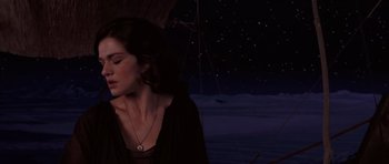 Movie still from “The Mummy Returns” (2001), directed by Stephen Sommers – A woman with her eyes closed under an open umbrella; Close Up shot, High angle
