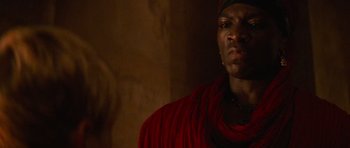 Movie still from “The Mummy Returns” (2001), directed by Stephen Sommers – A man in a red shirt is looking at the camera; Close Up shot, Low angle
