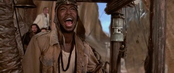 Movie still from “The Mummy Returns” (2001), directed by Stephen Sommers – An african american man wearing a pilot's hat; Close Up shot, Low angle