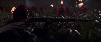Movie still from “The Mummy Returns” (2001), directed by Stephen Sommers – A group of people in a field with trees in the background; Medium shot, High angle