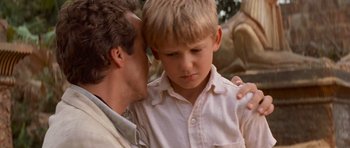 Movie still from “The Mummy Returns” (2001), directed by Stephen Sommers – A man and a boy are holding each other's head; Close Up shot, Low angle