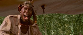 Movie still from “The Mummy Returns” (2001), directed by Stephen Sommers – A man holding an open umbrella with his mouth wide open; Close Up shot, Low angle